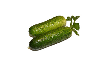Two green cucumbers lie nearby.