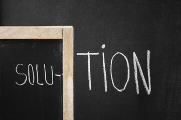 Inscription Solution writing on a blackboard. Front focus