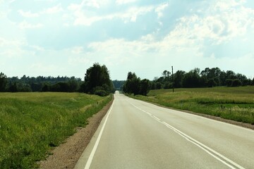 panoramic view with an asphalt road stretching into the distance and a blue sky in the background