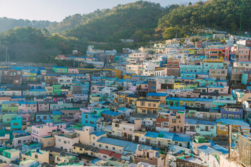 beautifully captures the dense, colorful hillside houses of Gamcheon Culture Village in Busan, Korea, presenting a vibrant and picturesque urban landscape.
