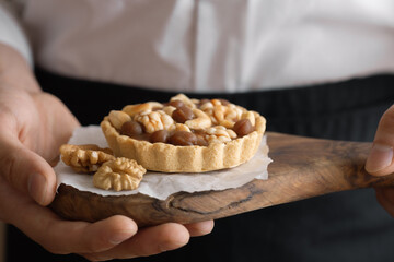 pastry chef training, nut tart in the hands of a young chef, homemade baking