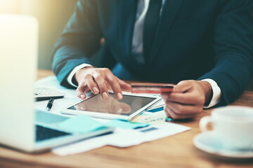 Businessman, hands and credit card for finance on tablet in office for payment, digital purchase or banking investment. Financial employee, fintech and stock market trading with startup loan at desk