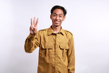 Happy Indonesian government employees standing while showing three fingers. Isolated on white