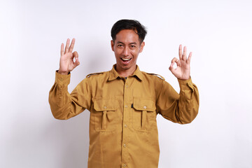 Satisfied Indonesian government employees standing while making okay hand gesture. Isolated on white