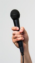 Hand holding a microphone with white background