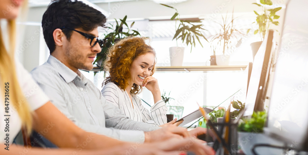 Aufkleber Tech Team Brainstorming in Contemporary Workplace: Tech-savvy group brainstorming ideas at their laptops, creating a creative and inspiring atmosphere in a contemporary workspace.