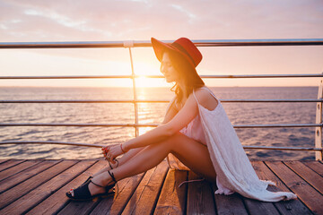 beautiful woman in white summer dress by the sea