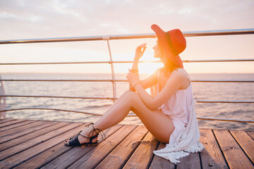 beautiful woman in white summer dress by the sea