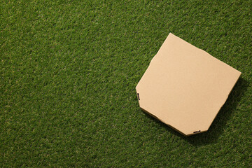 Ecological packaging for food delivery, on the grass.