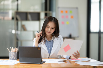 Businesswomen  Working and talking about work documents at the office.