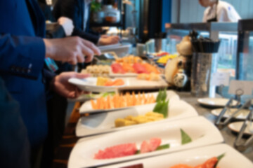 Blurred hand of chef take arranging food buffet japan food in hotel party, Food and drink