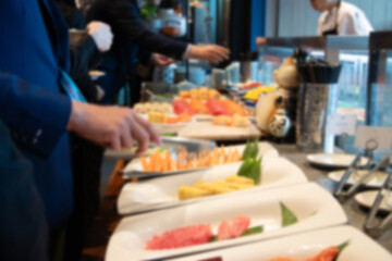 Blurred hand of chef take arranging food buffet japan food in hotel party, Food and drink