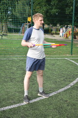 A young man in sportswear engages in a workout, using a sport tool for physical exercises on a...