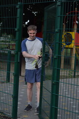 A young man in sportswear engages in a workout, using a sport tool for physical exercises on a...
