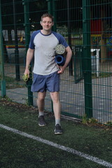 A young man in sportswear engages in a workout, using a sport tool for physical exercises on a...