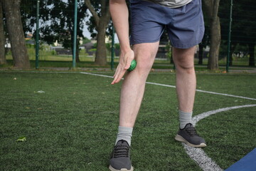 A young man in sportswear engages in a workout, using a sport tool for physical exercises on a...