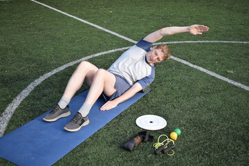 A young man in sportswear engages in a workout, using a sport tool for physical exercises on a...