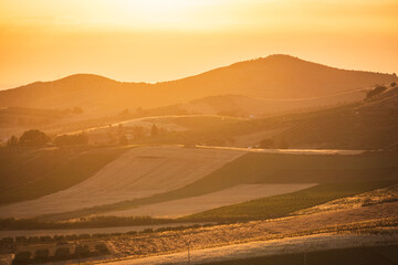 sunset over the hills with agriculture field classic italian landscape 