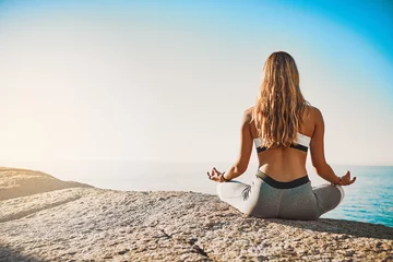 Fotobehang Lotusbloem Beach, back and woman with meditation for yoga, wellness and spiritual peace in California. Zen, female yogi and hands with lotus pose for chakra, relax and mental health by mockup space outdoor  © JorSons/peopleimages.com