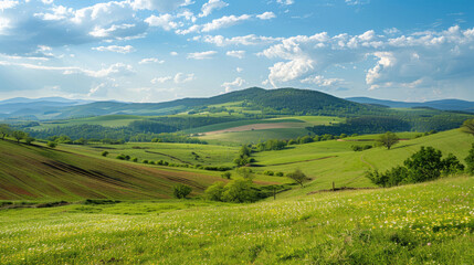 Obraz premium Hilly landscape with sunny skies and lush green fields