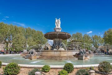Aix-En-Provence, France - 04 20 2023: View of the Rotunda Fountain with lions and three statues symbolizing justice, agriculture and art..