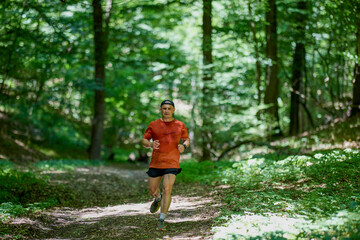 a strong middle-aged man running through the forest