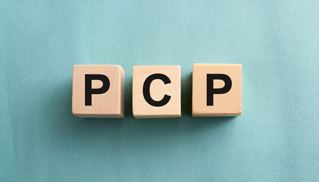 Wood blocks with abbreviation text PCP - primary-care physician. Medicine concept. Top view