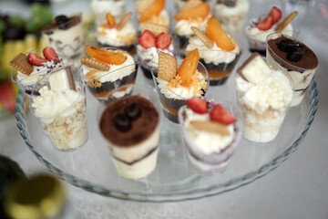 Sweet pastries and mousses on the buffet table. Decoration of a sweet buffet table.