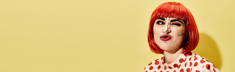 A stunning redhead adorned in a polka dot dress, showcasing a creative pop art makeup look against a bold yellow backdrop.