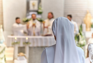 Nun at the holy mass in the church