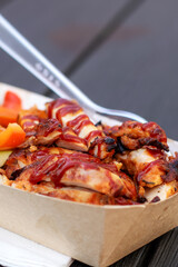 Fast food container with chicken, vegetables, and fork for convenience