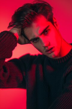 Fashion, art, and studio portrait of man in red with serious expression. Beauty, wellness, designer ads, gorgeous men in red light, and seductive looks