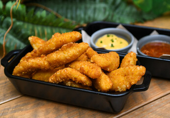 Serving of battered and fried chicken fingers
