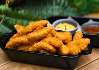 Serving of battered and fried chicken fingers

