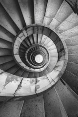 A mesmerizing spiral staircase captured in a monochromatic photo