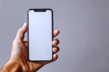 A hand holding smartphone with white screen on gray background, Mockup for  presentation , banner concept , have space for background