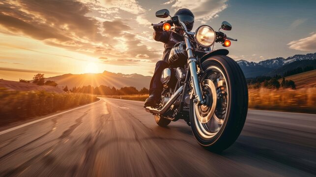 A motorcyclist rides on a scenic highway at sunset, capturing the spirit of adventure and freedom on the open road.