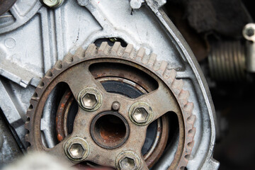 A rusty gear is shown in a close up. The gear is old and worn, and it is not in good condition