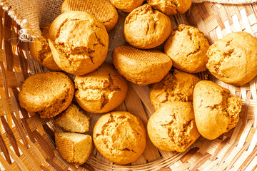 Lots of buns in a wicker basket. Close-up. Fresh morning pastries.