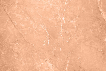 Stone surface of peach fuzz color, top view. Trendy shade of 2024 year