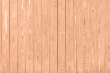 Wooden surface of peach fuzz color, top view. Trendy shade of 2024 year