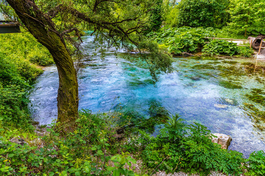 A view from the river bank down the river fed by the Blue eye spring in Muzine, Albania in summertime