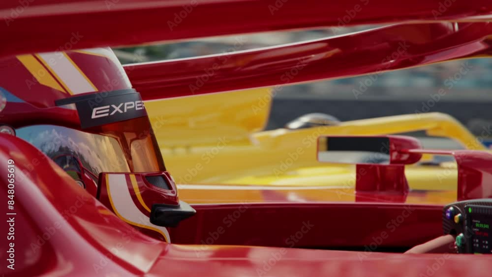Aufkleber side view close-up of a race car driver wearing a protective helmet driving along the race track and