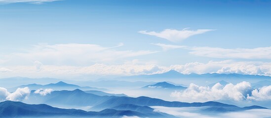 Clouds falling on mountains in blue sky background. Creative banner. Copyspace image