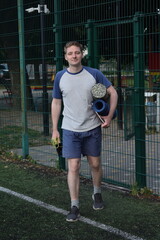 A young man in sportswear engages in a workout, using a sport tool for physical exercises on a...