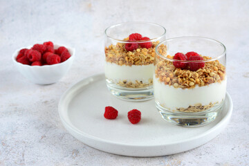 a snack of yogurt with raspberries and oat flakes  