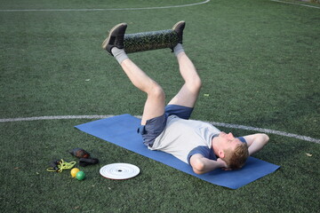 A young man in sportswear engages in a workout, using a sport tool for physical exercises on a...