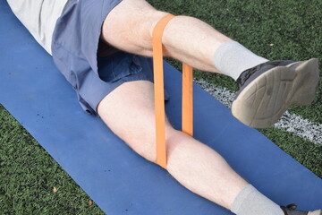 A young man in sportswear engages in a workout, using a sport tool for physical exercises on a...