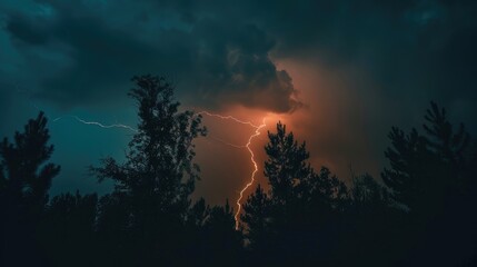Fototapeta premium Lightning flashing amidst dark night skies over the trees