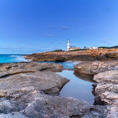 long exposure view of the Cap de ses Salines Lighthouse on Mallorca just before sunrise